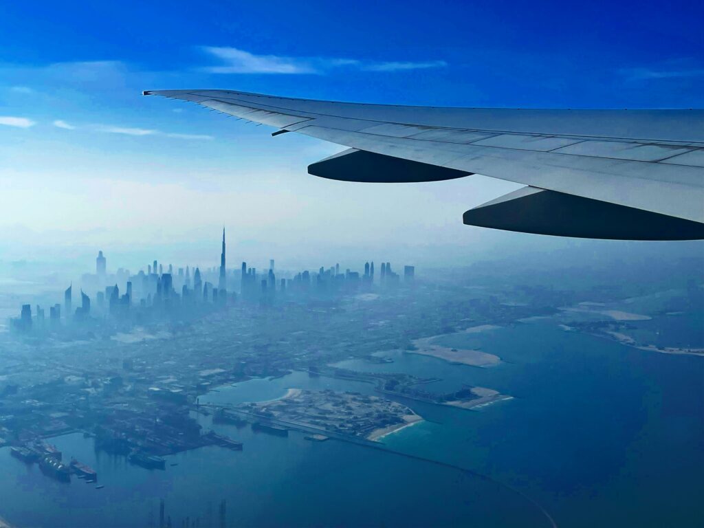 Avión aterrizando en Dubái con la ciudad al fondo